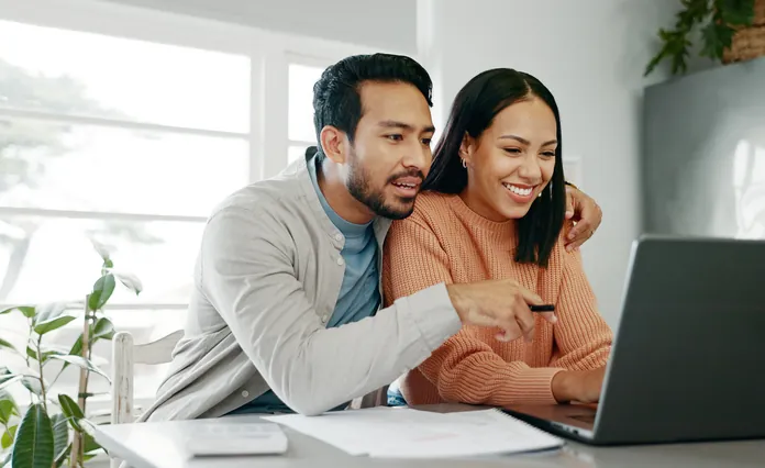 A Jacksonville couple reviewing home financing options together on a laptop