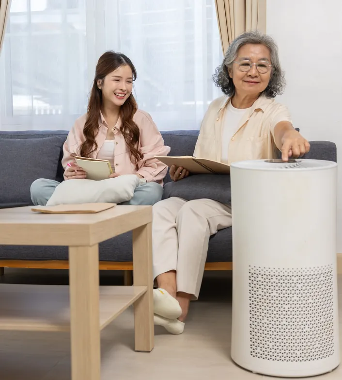Family relaxing at home beside an air purifier